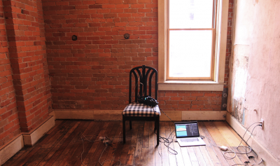 A VR Headset sits in an empty room on a chair